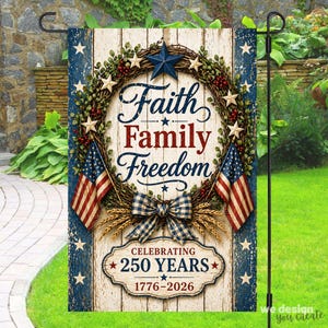 May include: A garden flag with a patriotic theme. The flag features the words "Faith Family Freedom" in blue and red, surrounded by a wreath and American flags. It also says "Celebrating 250 Years 1776-2026".