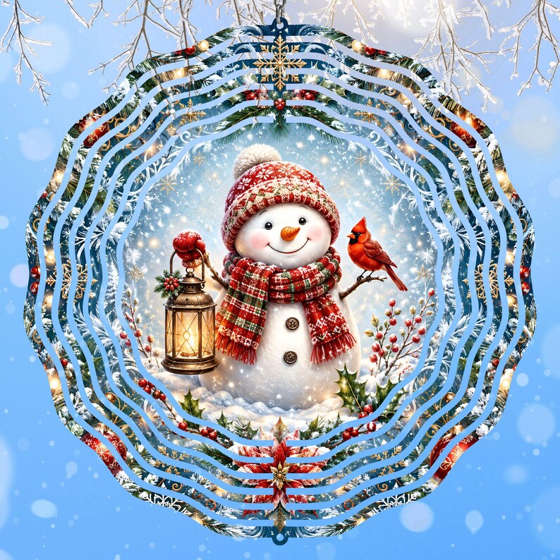 May include: A circular metal wind spinner featuring a central illustration of a snowman wearing a red patterned hat and scarf. The snowman holds a lit lantern, with a red cardinal perched on a branch nearby, surrounded by holly and snowflakes.