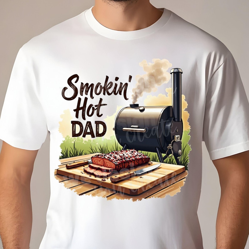 May include: White t-shirt with a graphic of a smoker with smoke coming out of it, a piece of meat on a cutting board, and the text "Smokin' Hot DAD".