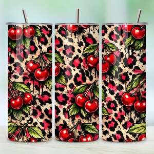 May include: A set of three stainless steel tumblers with lids and straws. The tumblers feature a vibrant design of red cherries and green leaves against a leopard print background with black drips.