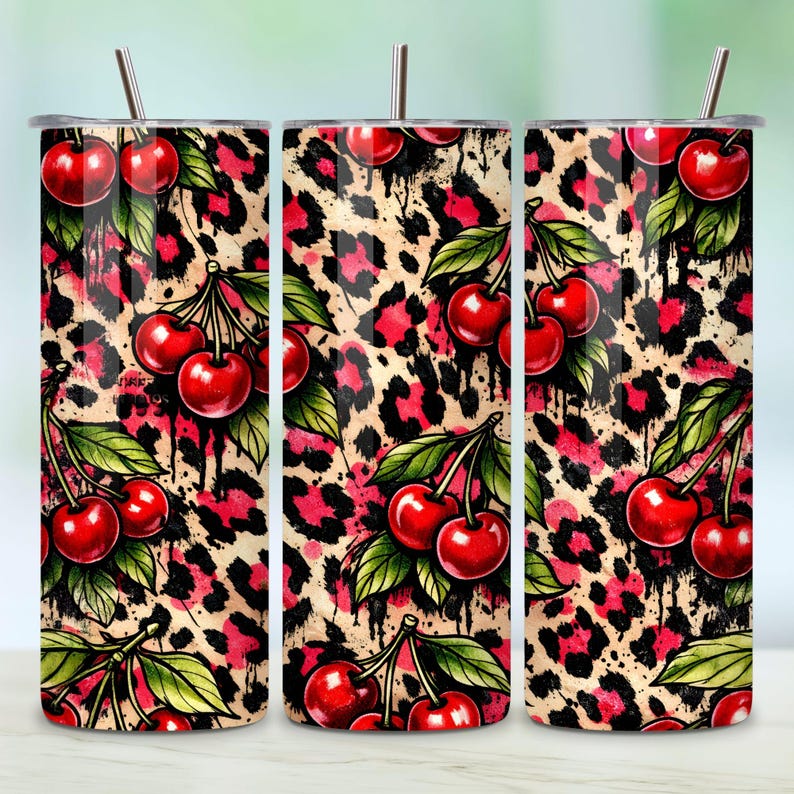 May include: A set of three stainless steel tumblers with lids and straws. The tumblers feature a vibrant design of red cherries and green leaves against a leopard print background with black drips.