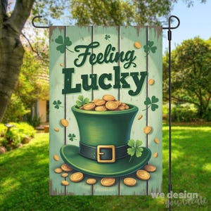 May include: A garden flag with a St. Patrick's Day theme. The flag features a green top hat filled with gold coins, shamrocks, and the words "Feeling Lucky" in a whimsical font. The background is a light green wooden texture.