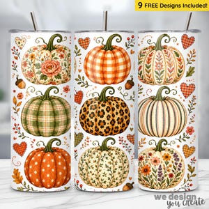 May include: Three white cylindrical tumblers with straws, each featuring a repeating pattern of various pumpkins decorated with floral, plaid, leopard, and polka dot prints, interspersed with small orange hearts and autumn leaves.