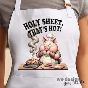 May include: White apron with a cartoon pig chef holding a pie. The apron has the text "HOLY SHEET, THAT'S HOT!". The pig is wearing a chef's hat and oven mitts. A pie is on a baking sheet, and a cutting board is nearby.