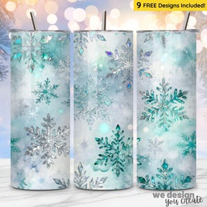 May include: Three stainless steel tumblers with a winter theme. Each tumbler features a design of snowflakes in shades of silver and teal against a light blue and white watercolor background. The text "9 FREE Designs Included!" is visible.