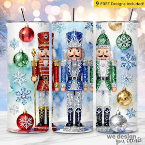 May include: Three stainless steel tumblers with Christmas designs. Each tumbler features a nutcracker soldier in red, blue, and green uniforms, with sparkling details. The background includes watercolour washes, snowflakes, and ornaments. The text "9 FREE Designs Included!" is visible.