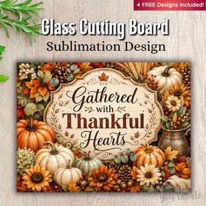 May include: A glass cutting board sublimation design featuring the text Gathered with Thankful Hearts on a central plaque, surrounded by orange and white pumpkins, sunflowers, pinecones, wheat stalks, and autumn leaves in shades of red and gold.