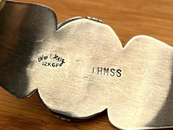 The IHMSS mark, photographed on a piece