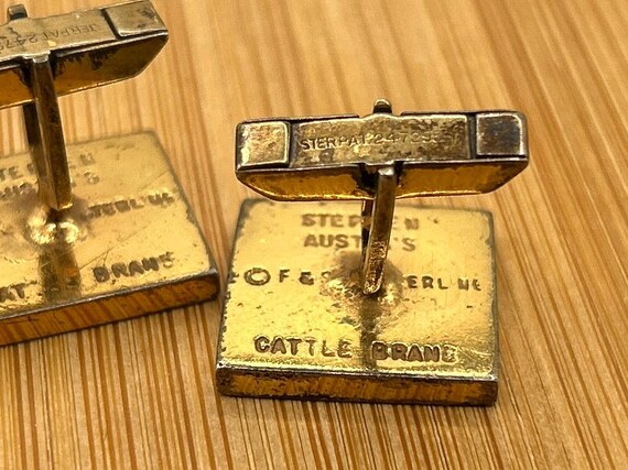 The CATTLE BRAND mark, photographed on a piece