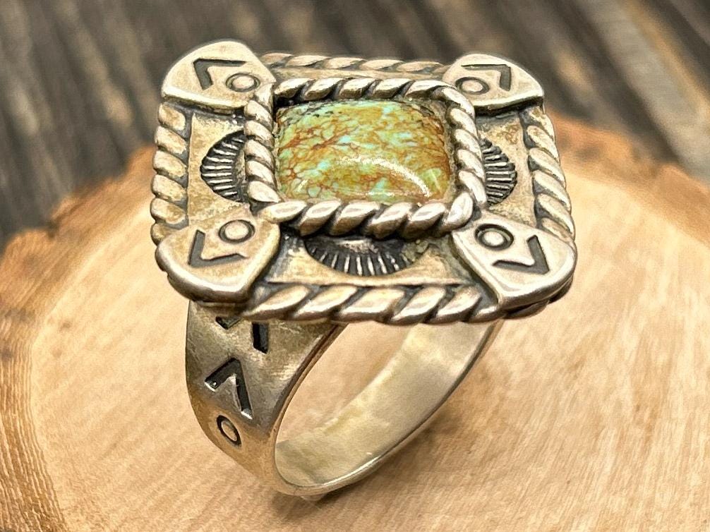 Sterling silver cuff bracelet featuring intricate filigree wirework, floral clusters, and semiprecious gemstone settings.