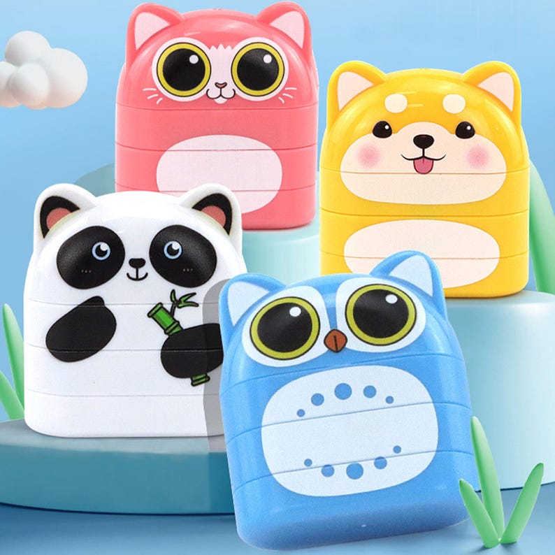 May include: Four colorful animal-shaped toys: a pink cat, yellow dog, white panda, and blue owl. Each toy has large, expressive eyes and a stacked design. The panda holds bamboo, and the dog has a pink blush.