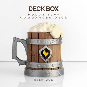 May include: A brown wooden beer mug shaped deck box with silver metal-look bands and a handle. The top features white foam, and the front displays a shield emblem with a yellow flame icon. Text reads: DECK BOX, HOLDS 100+ COMMANDER DECK, BEER MUG.