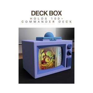 May include: A light purple deck box shaped like a retro television, with the text "DECK BOX HOLDS 100+ COMMANDER DECK". The screen displays a Magic: The Gathering card. The box has a blue antenna and knobs.