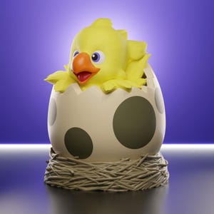 May include: A yellow bird figurine with a bright orange beak and purple eyes emerging from a cream-coloured eggshell with large dark grey spots. The egg rests inside a textured, light brown nest base, creating a detailed decorative sculpture.