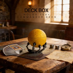 a deck box containing a yellow globe-like object, a deck of cards, and a compass, all placed on a wooden table.