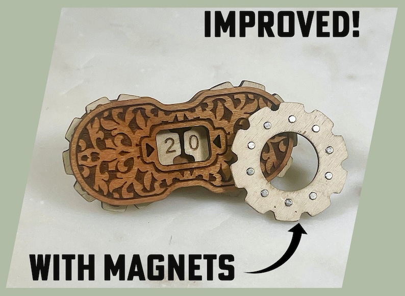 May include: A wooden calendar with a decorative design and a gear-shaped magnet attached. The calendar displays the number "20" and the text "IMPROVED! WITH MAGNETS" is visible below the image.