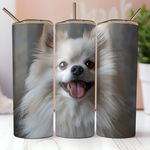 以下が含まれることがあります： 白いふわふわの犬が描かれたステンレス製のタンブラーが3つ。犬は茶色の目で、ピンクの舌を出しています。犬の顔は各タンブラーの中心に配置されています。