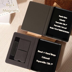 May include: A dark gray magnetic tablet case with a stand and hand strap. The case is open, revealing a black tablet with white text indicating compatibility with various Kindle models, including Paperwhite 12th 7" and 11th 6.8".
