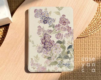 May include: A white and purple floral design on a book cover with the word "Daisy" written in cursive.