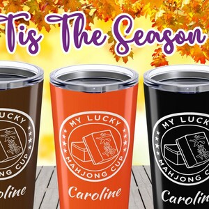 May include: Three insulated tumblers in brown, orange, and black, each with a silver rim and lid. The tumblers feature a white circular design with the text "MY LUCKY MAHJONG CUP" and a personalized name. The words "Brown", "Orange", and "Black" are below each tumbler.