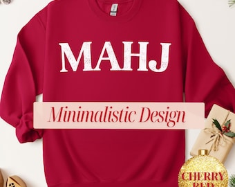 May include: Cherry red sweatshirt with the letters "MAHJ" in white, above a banner that reads "Minimalistic Design". A gold glitter ornament with "Cherry Red" text is in the lower right corner.