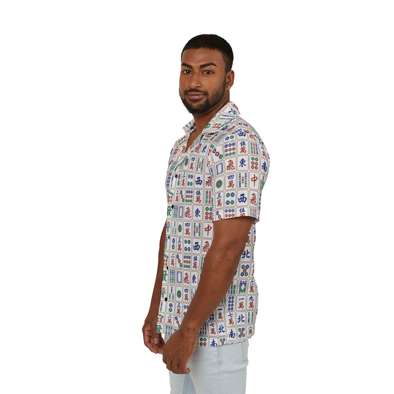 May include: A white short-sleeved button-down shirt with a colorful pattern of Chinese mahjong tiles.