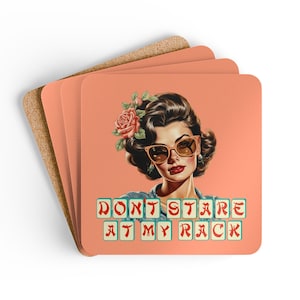 May include: Square coasters with a retro illustration of a woman wearing sunglasses and a flower in her hair. The coasters have the text "DON'T STARE AT MY RACK" in a tile-like font. The background is a solid peach color.