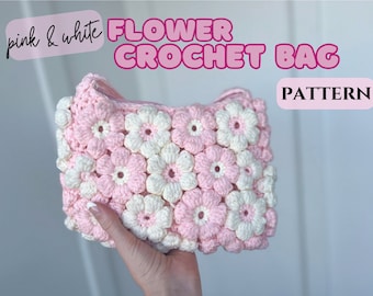 May include: A pink and white flower crochet bag. The bag is covered in crocheted flowers in pink and white. The text "pink & white FLOWER CROCHET BAG PATTERN" is displayed on the image.