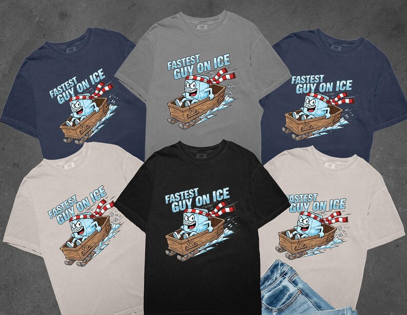 May include: Various t-shirts in navy, grey, black, and beige. Each has a cartoon ice cube sledding, with the text "FASTEST GUY ON ICE" above. The ice cube is wearing a red and white scarf, a fun design for clothing.