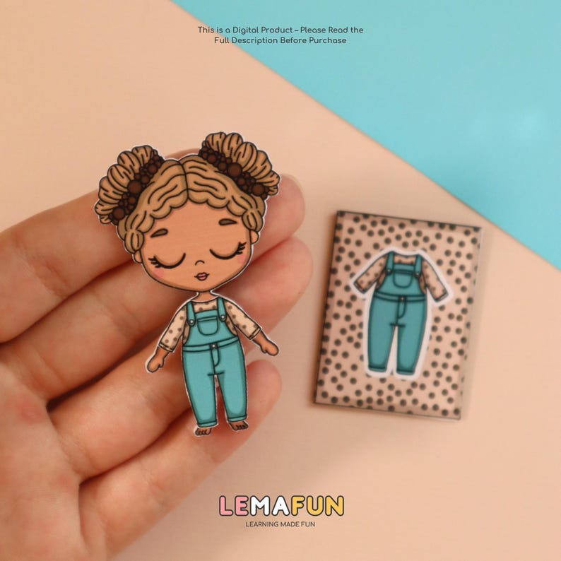 May include: A cartoon doll with brown hair in pigtails wearing a teal jumpsuit and a matching outfit on a small card. The doll is held in a hand. The text "LEMAFUN LEARNING MADE FUN" is at the bottom.