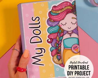 May include: A colourful "My Dolls" notebook featuring a cartoon girl with rainbow hair. The notebook has a pink, yellow, and blue striped background. A digital download circle with text is in the lower right corner.