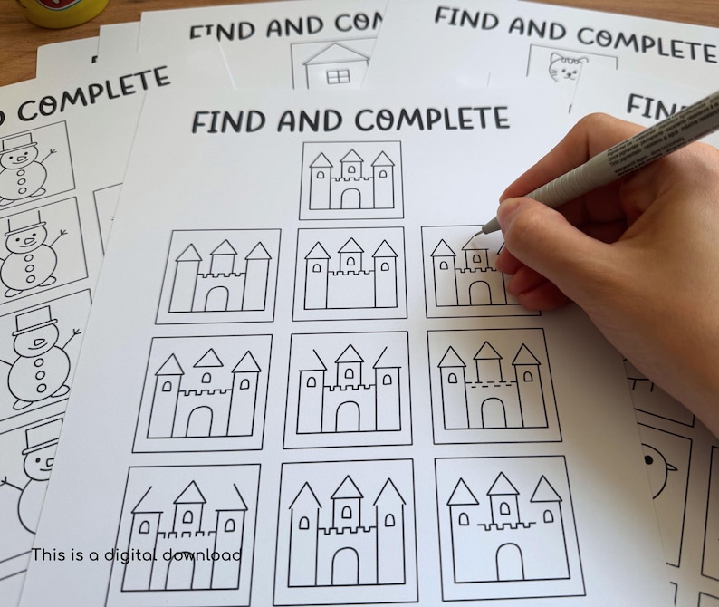 May include: White paper sheets with the text "FIND AND COMPLETE" and line drawings of castles and snowmen. A hand is holding a pen and completing the castle drawing. The text "This is a digital download" is at the bottom.