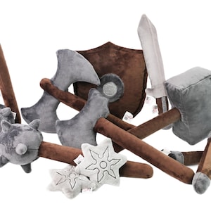 Complete set of plush medieval weapons and shield for imaginative play. Includes axe, sword, hammer, shield, stars, and more. Soft, safe, durable. Handmade by GraTy Foundation. Every purchase supports social initiatives and education projects!
