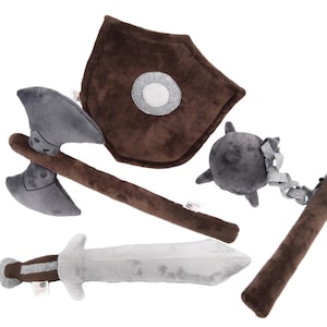 Complete plush medieval weapon set for imaginative play. Includes sword, shield, axe, and flail. Soft, safe, and durable, perfect for kids and fantasy fans. Crafted by GraTy Foundation, each purchase supports social initiatives. Adventure starts here