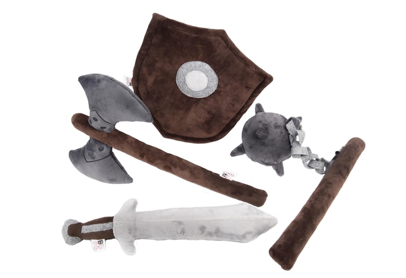 Complete plush medieval weapon set for imaginative play. Includes sword, shield, axe, and flail. Soft, safe, and durable, perfect for kids and fantasy fans. Crafted by GraTy Foundation, each purchase supports social initiatives. Adventure starts here