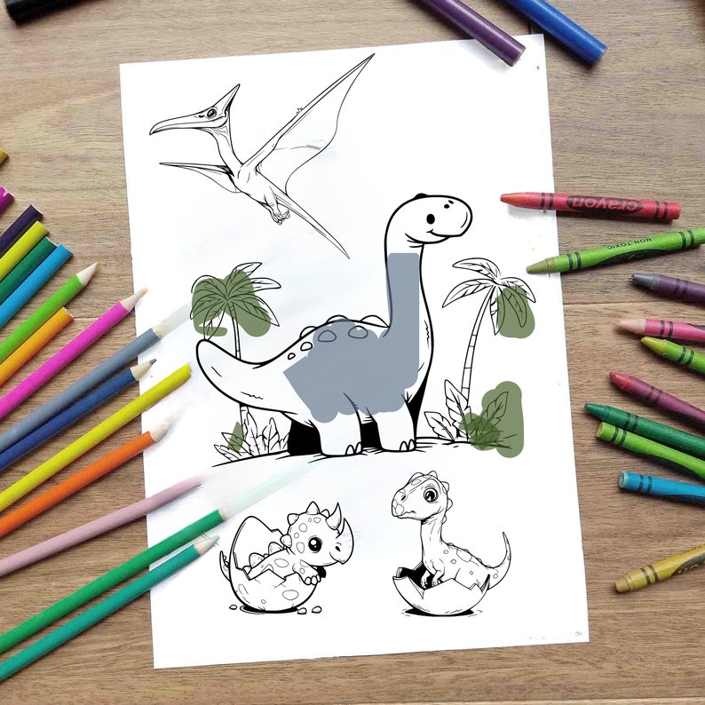 May include: A black and white colouring page featuring a dinosaur, a pterodactyl, and two baby dinosaurs hatching from eggs. The dinosaurs are surrounded by palm trees and green foliage.