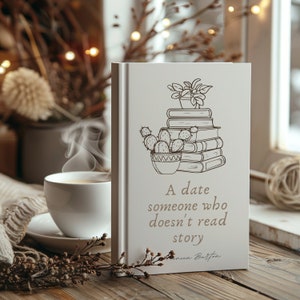 May include: A white journal with a quote that reads "A date someone who doesn't read story". The journal has a black and white illustration of a potted plant and a stack of books.