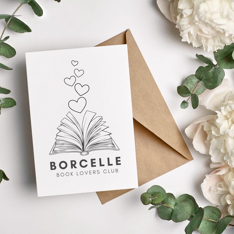 May include: A white card with a black and white illustration of an open book with hearts floating above it. The text "BORCELLE BOOK LOVERS CLUB" is printed below the illustration.