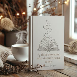 May include: A white book with a black and white illustration of an open book with hearts floating above it. The text on the book reads "A date someone who doesn't read story".