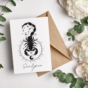 May include: A black and white illustration of a scorpion with a crescent moon and stars. The text "Scorpio" is written below the scorpion.