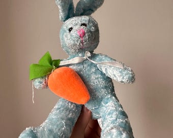 bunny rabbit eating carrot plushie.