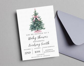May include: A white invitation card with a watercolor illustration of a Christmas tree with a pink bow. The text reads "You're invited to a Baby Shower honoring Lindsay Smith, December 22nd, 11am, Blake Residence, 1234 Roseln, Seattle WA 90335, rssp-124.345.3533, Registered at Amazon."