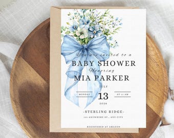May include: A blue and white baby shower invitation with a watercolor illustration of a bouquet of flowers tied with a blue ribbon. The invitation text reads "You are invited to a Baby Shower Honoring Mia Parker" and includes the date, time, and location of the event.