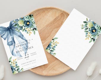 May include: A blue and green floral design with a blue ribbon bow on a white card. The card reads "You are invited to a Sprinkle honoring Riley James".