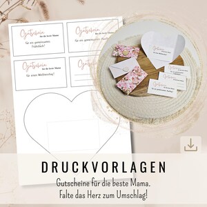 May include: Printable gift certificate templates for Mother's Day. The templates feature a heart-shaped design that can be folded into an envelope. The text on the templates reads "Gutschein für die beste Mama" which translates to "Gift certificate for the best mom".