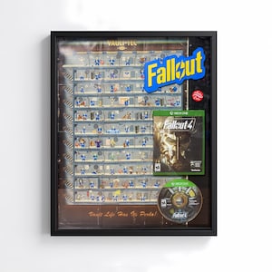 May include: Framed Fallout artwork featuring a detailed schematic of a Vault-Tec vault, the Fallout logo, and a Fallout 4 Xbox One game case and disc. The artwork is in a black frame.