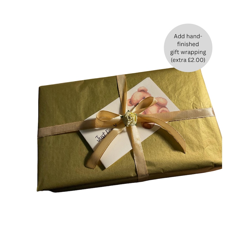 May include: A gold gift box wrapped in tissue paper with a yellow ribbon and a card that says "Just For You".