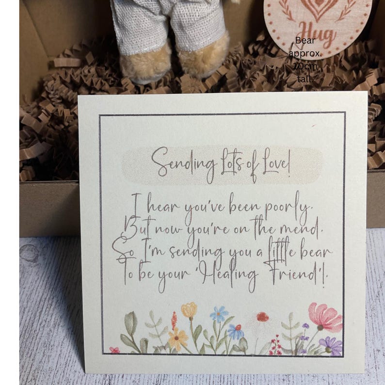 May include: A card with a floral border and the text "Sending Lots of Love! I hear you've been poorly. But now you're on the mend. So I'm sending you a little bear To be your Healing Friend!"