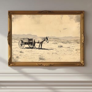 May include: A black and white vintage photograph of a horse pulling a wagon across a desert landscape. The image is framed in a gold frame.