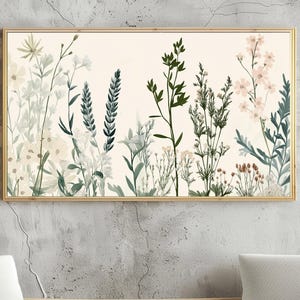 Può includere: Una stampa incorniciata con un'illustrazione botanica di vari fiori e piante in tonalità di verde, bianco e rosa su uno sfondo crema.
